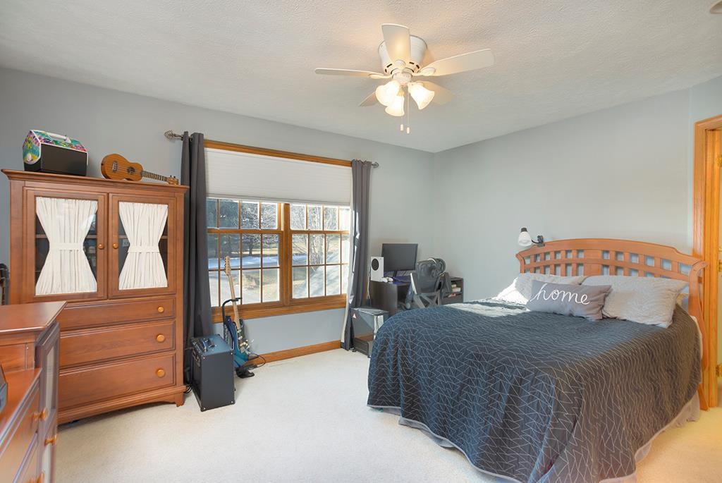 966 Spring Ridge Court Belvidere, IL 61008 - Photo 23 of 44 a bedroom with a bed and a dresser