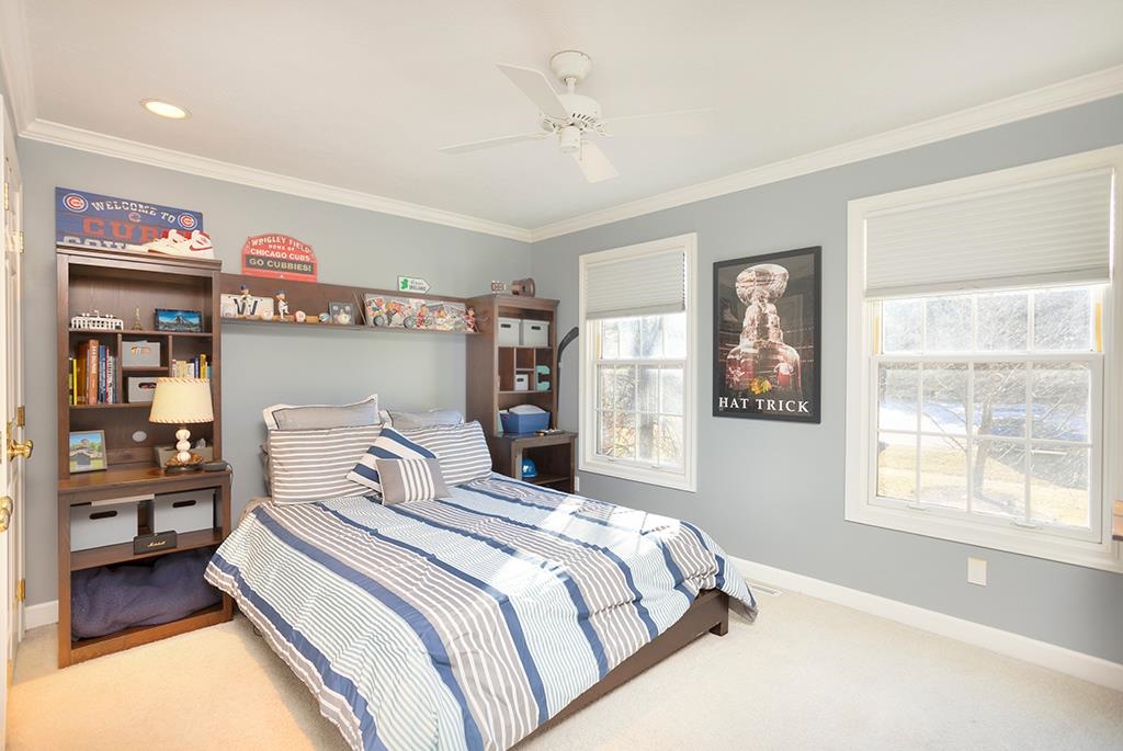 966 Spring Ridge Court Belvidere, IL 61008 - Photo 25 of 44 a bedroom with a large bed and a window
