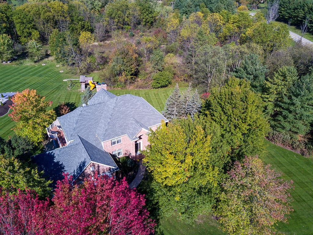 966 Spring Ridge Court Belvidere, IL 61008 - Photo 44 of 44 an aerial view of a house with a yard and lake view