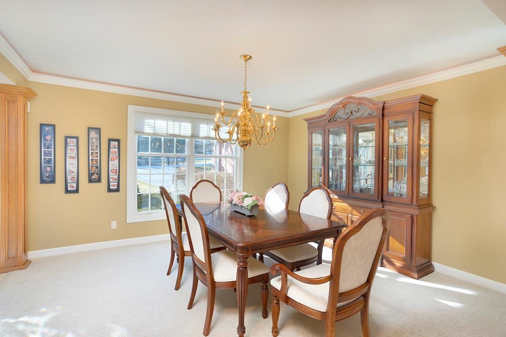 966 Spring Ridge Court Belvidere, IL 61008 - Photo 9 of 44 a dining room with furniture a chandelier and wooden floor