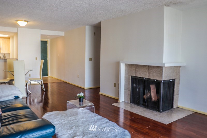 611 Southwest 5th Court, Unit A301 Renton, WA 98057 - Photo 1 of 17 a living room with furniture and a fireplace