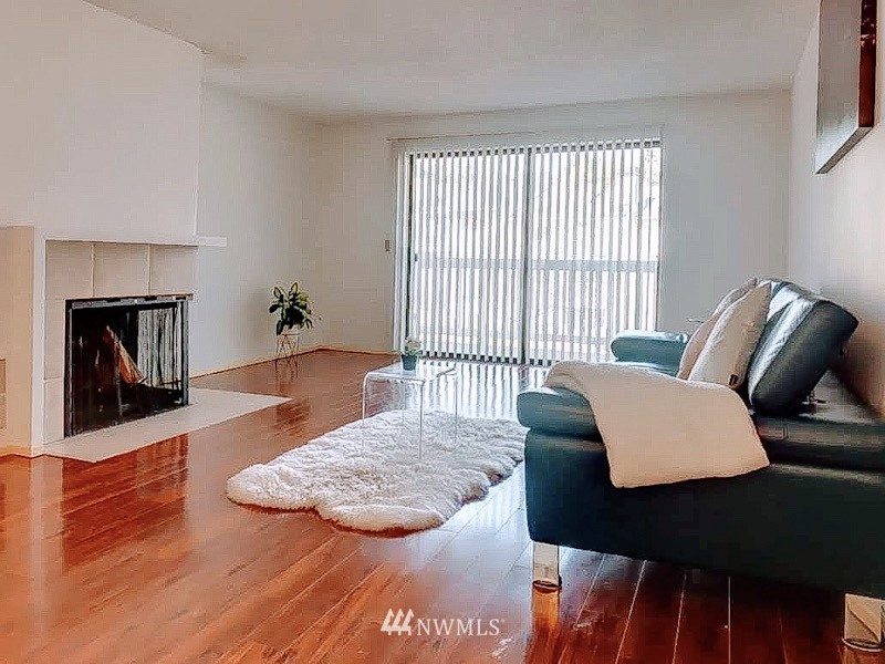 611 Southwest 5th Court, Unit A301 Renton, WA 98057 - Photo 2 of 17 a living room with furniture and a fireplace