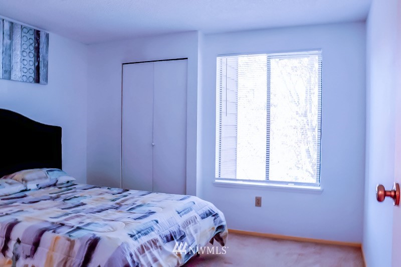611 Southwest 5th Court, Unit A301 Renton, WA 98057 - Photo 15 of 17 a bedroom with a bed and a flat tv screen