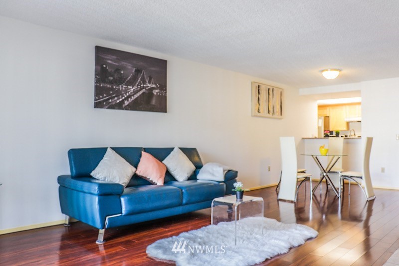 611 Southwest 5th Court, Unit A301 Renton, WA 98057 - Photo 3 of 17 a living room with furniture and wooden floor