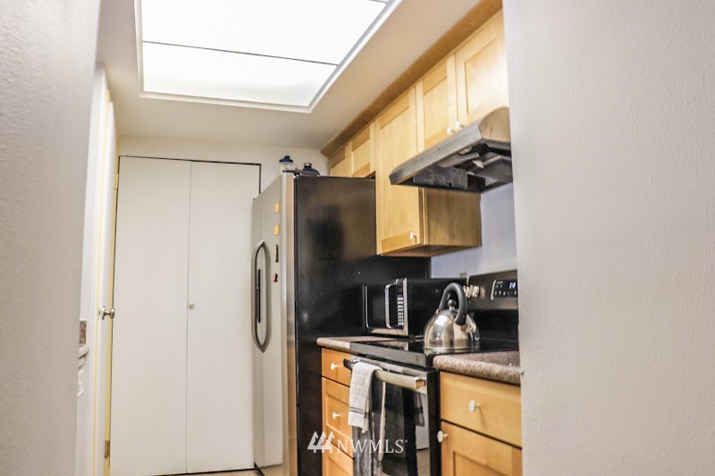 611 Southwest 5th Court, Unit A301 Renton, WA 98057 - Photo 6 of 17 a kitchen with a refrigerator and a stove