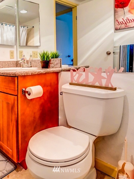 611 Southwest 5th Court, Unit A301 Renton, WA 98057 - Photo 10 of 17 a bathroom with a toilet sink and mirror