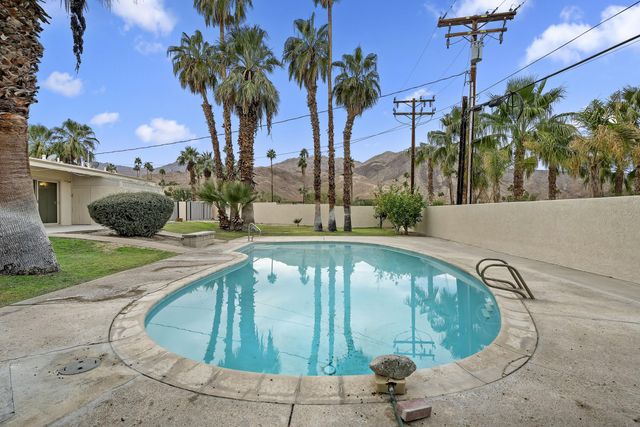 a view of a swimming pool with a patio