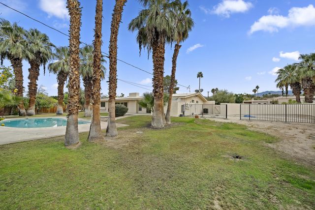 a view of a garden with a house