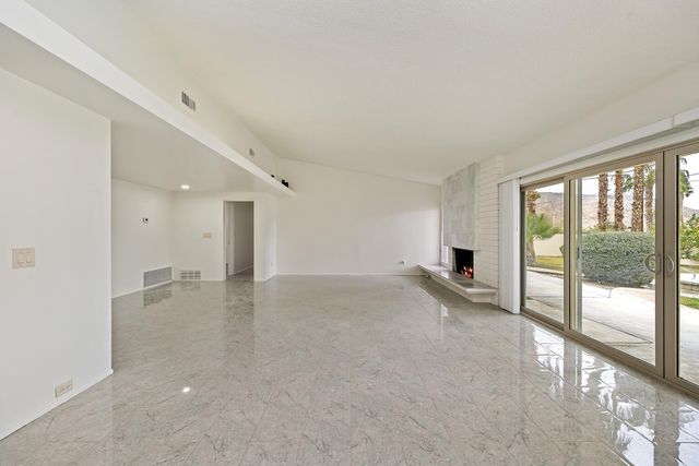 a view of empty room with floor to ceiling window