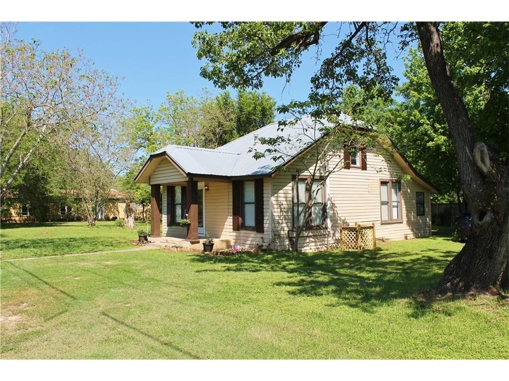 219 Lexington Road Elgin, TX 78621 - Photo 1 of 1 a front view of a house with garden