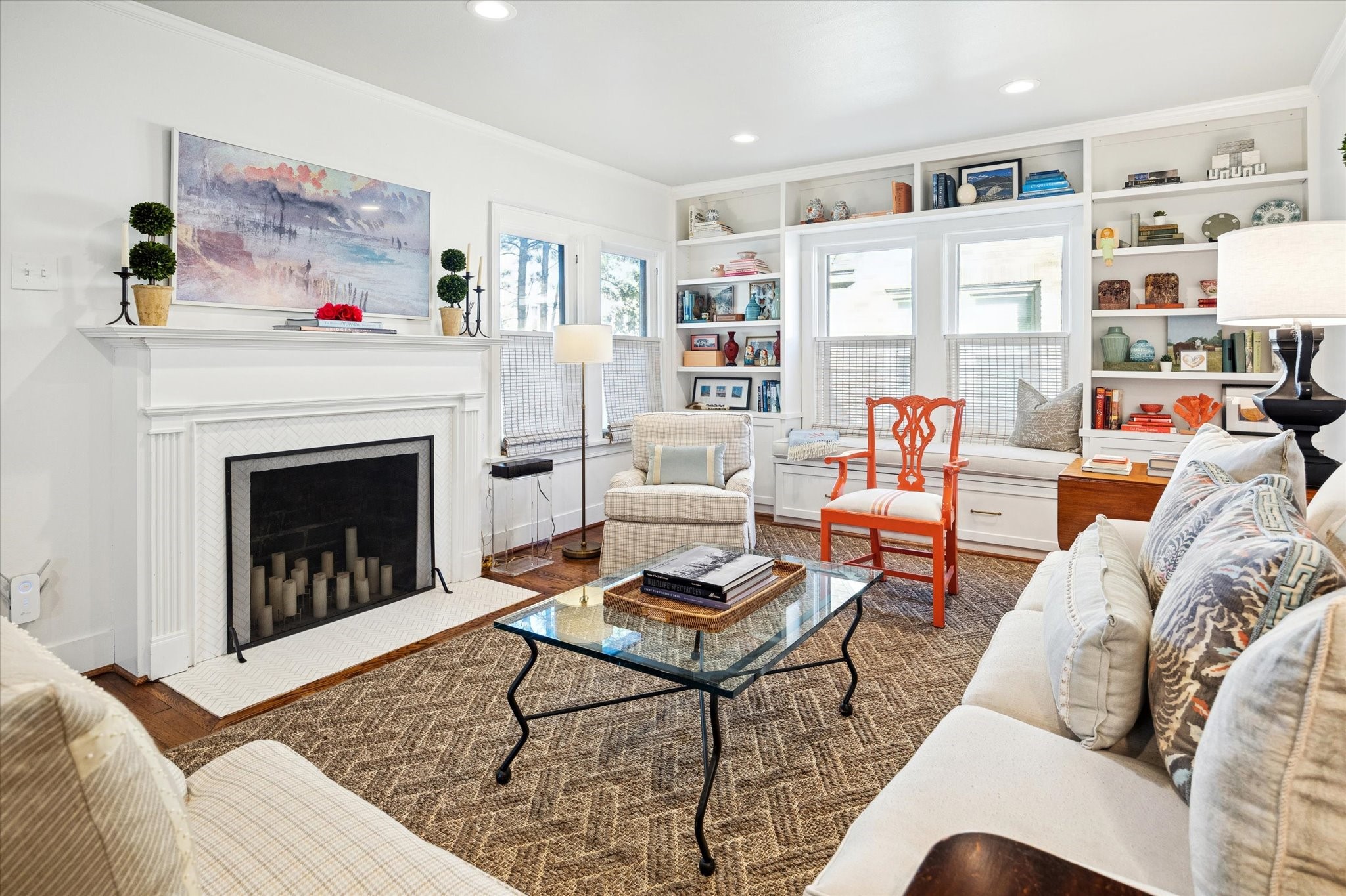 2109 Colquitt Street Houston, TX 77098 - Photo 4 of 28 The light-filled living room features hardwood floors, recessed lighting, custom built-ins, and a classic fireplace as a focal point.