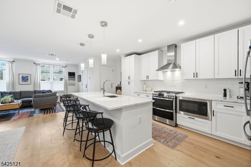 14 Ward Street Bloomfield, NJ 07003 - Photo 13 of 33 a kitchen with stainless steel appliances kitchen island granite countertop a table chairs sink and cabinets