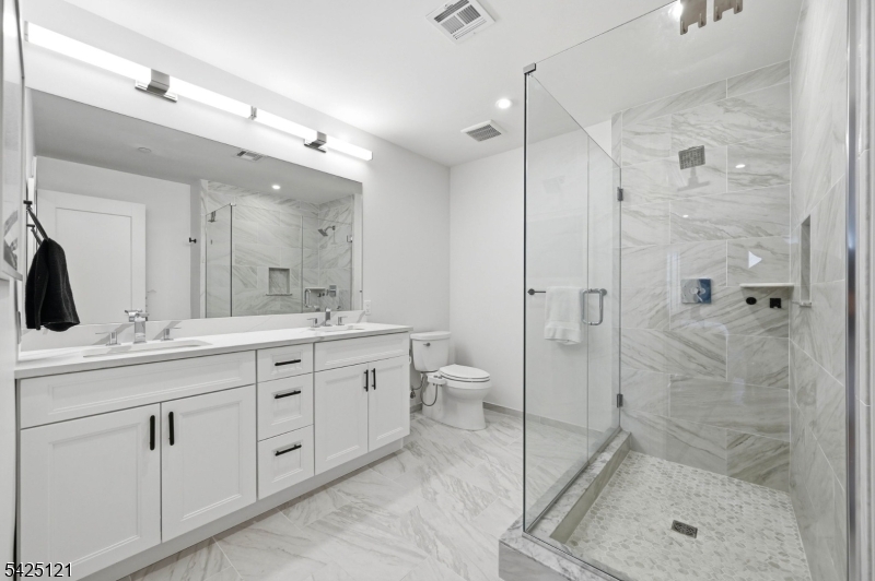 14 Ward Street Bloomfield, NJ 07003 - Photo 22 of 33 a bathroom with a double vanity sink toilet and shower
