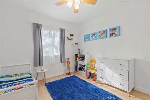 a children room with toys and a window