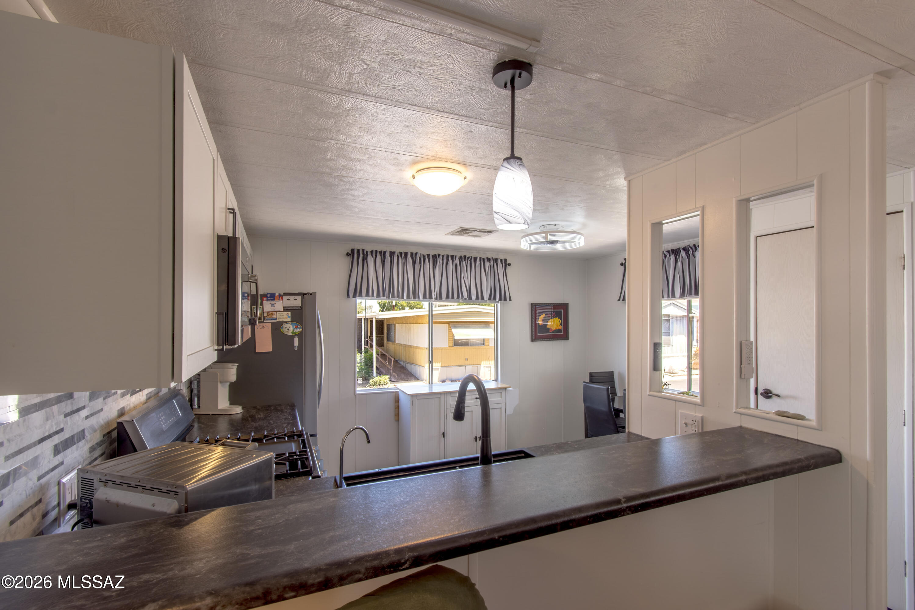 4550 North Flowing Wells Road, Unit 155 Tucson, AZ 85705 - Photo 12 of 40 a kitchen with sink and window