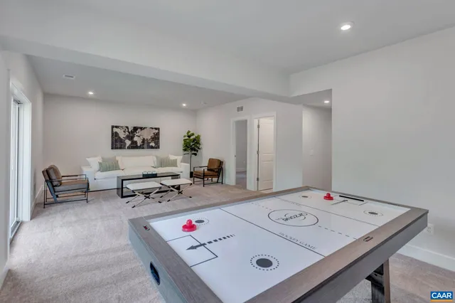 a living room with game table