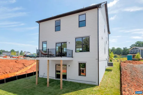 a view of a house with backyard porch and sitting area