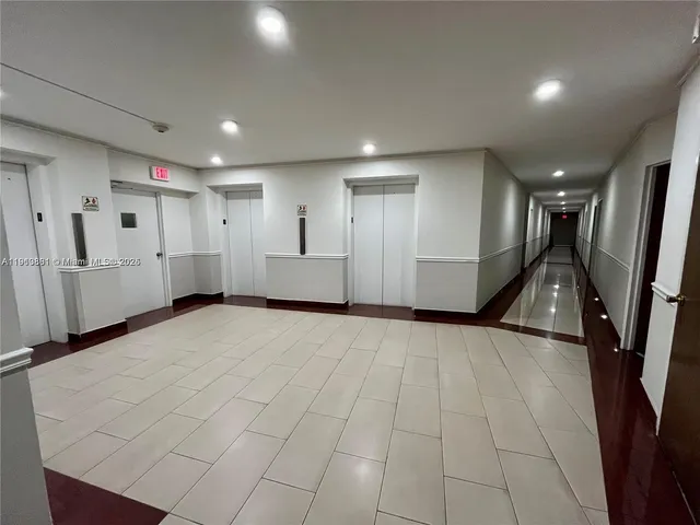 a view of a hallway with two chairs