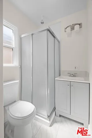 a view of a room with wooden floor and fan