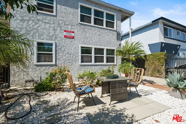 a view of a chair and table in the backyard