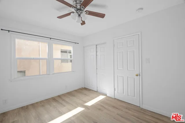 a view of a room with wooden floor and white walls