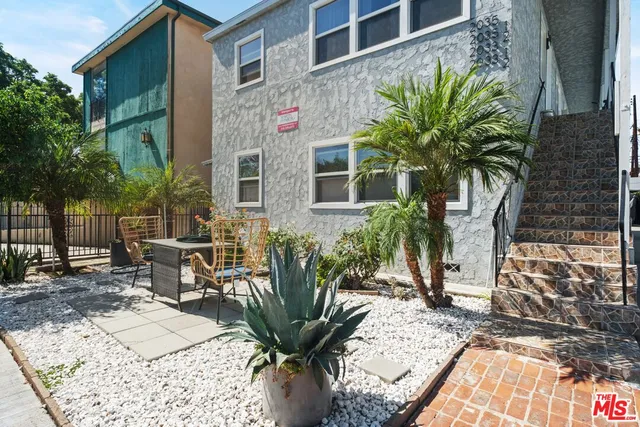 a view of a chairs and table in backyard