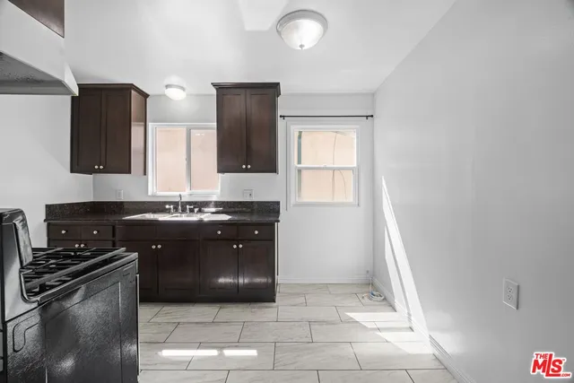 a kitchen with stainless steel appliances granite countertop a stove and a refrigerator