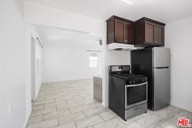 a kitchen with granite countertop a sink and a stove