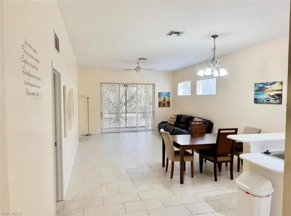 a kitchen with stainless steel appliances a refrigerator a sink a stove top oven a washer and dryer