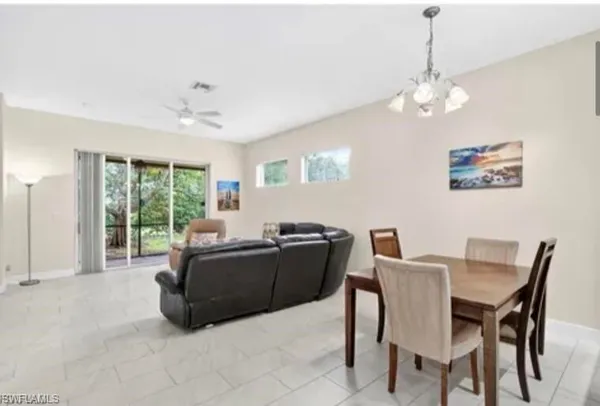 a white house that has tree in front of it