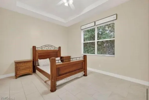 a bed room with a bed and a chandelier