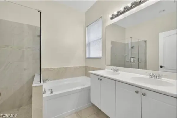 a living room with furniture a large window and a chandelier