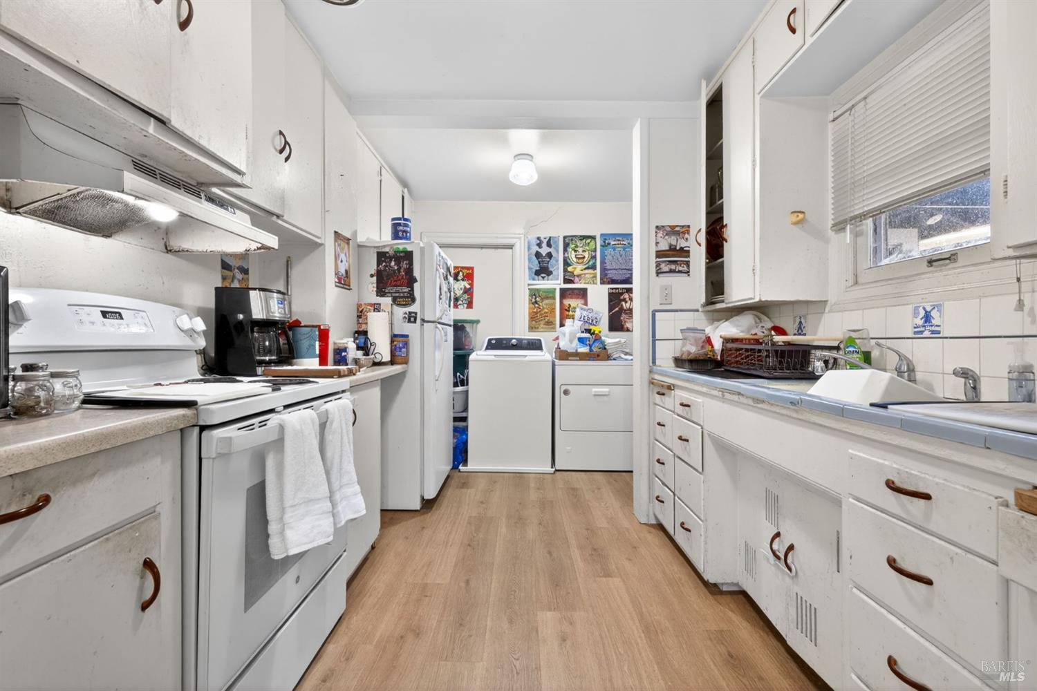 689 Plum Drive Santa Rosa, CA 95404 - Photo 15 of 26 a kitchen with counter top space a sink cabinets and stainless steel appliances