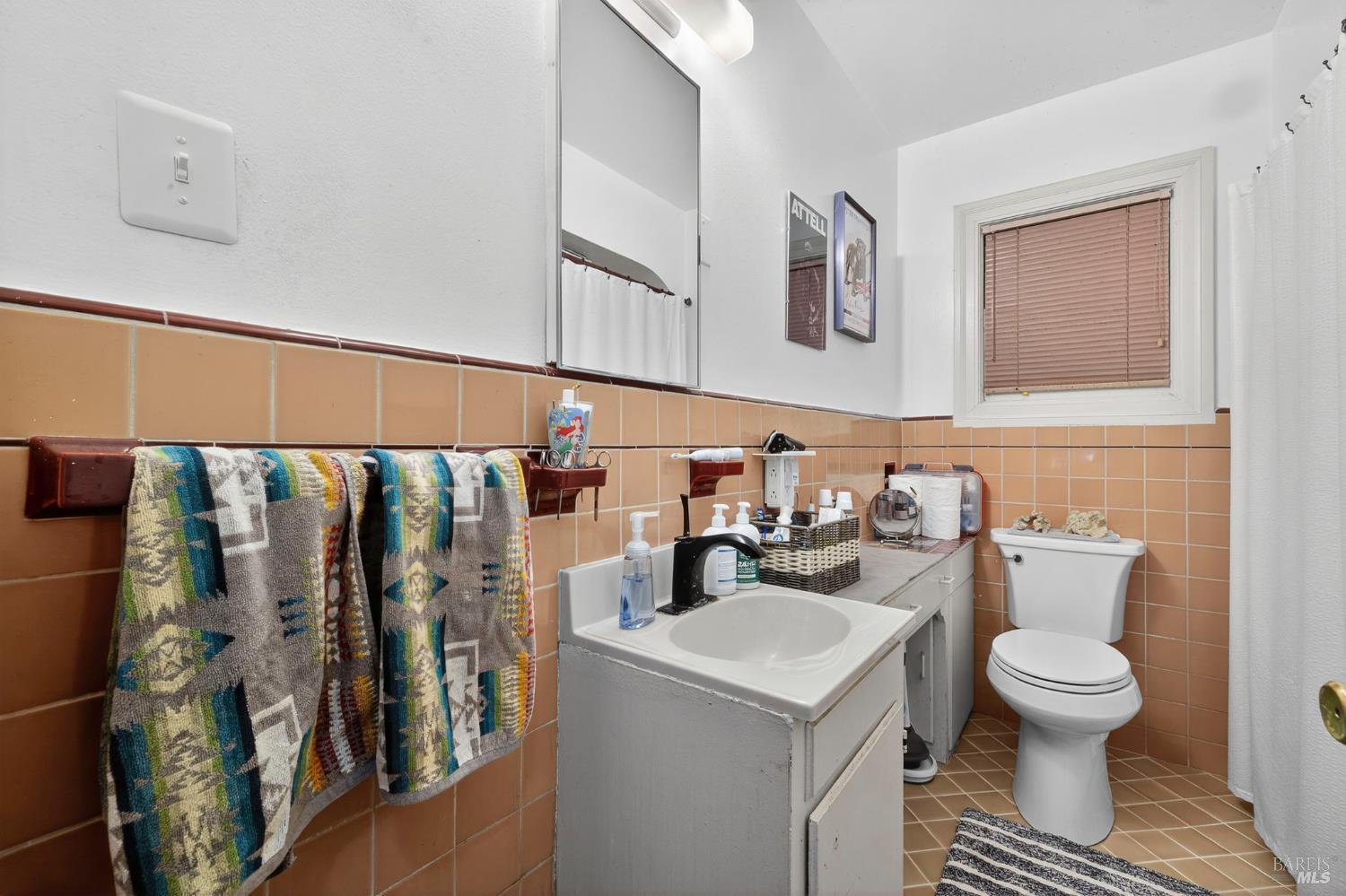 689 Plum Drive Santa Rosa, CA 95404 - Photo 16 of 26 a bathroom with a toilet sink and mirror