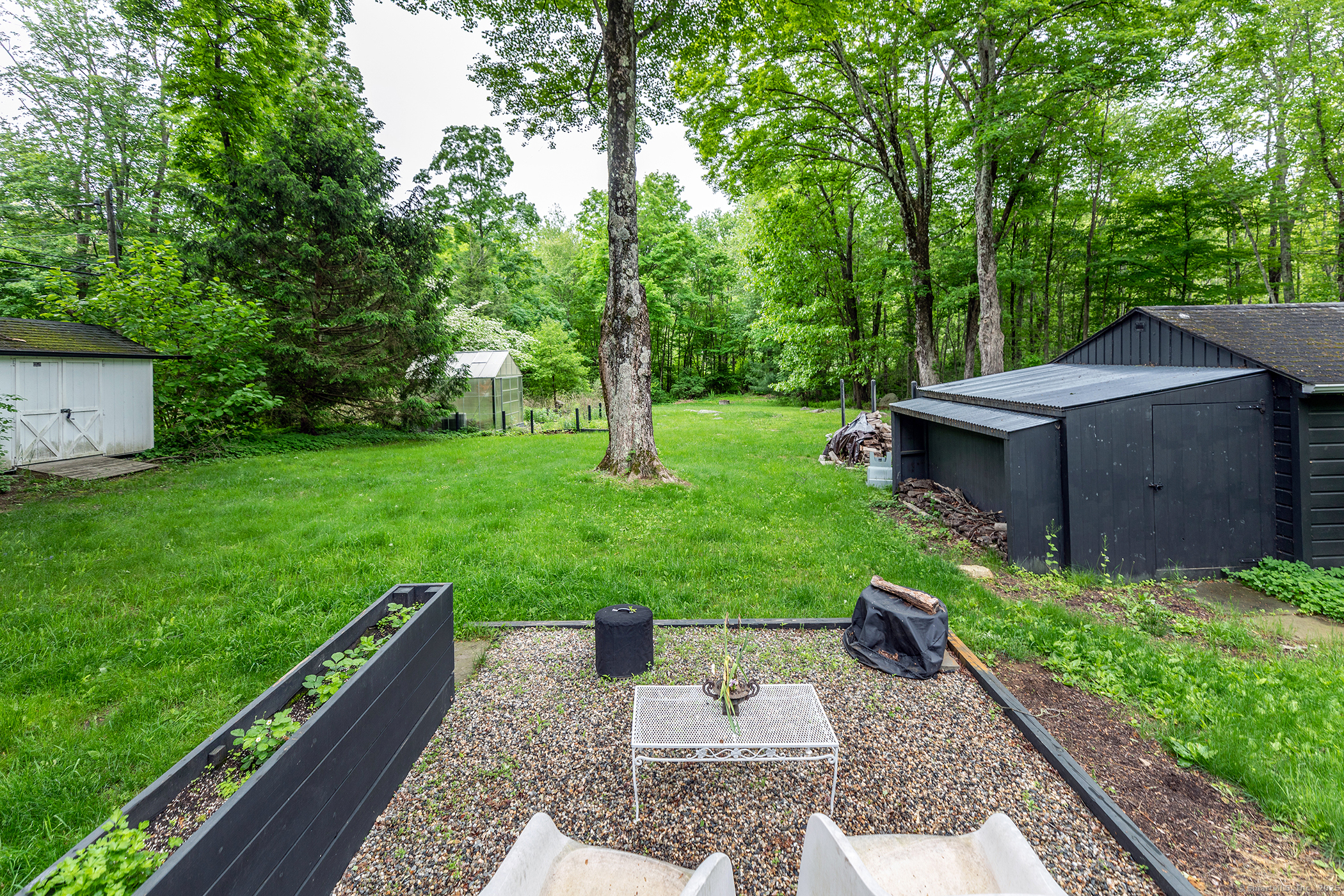 255 Aspetuck Ridge Road New Milford, CT 06776 - Photo 25 of 33 Gravel firepit area overlooking expansive yard