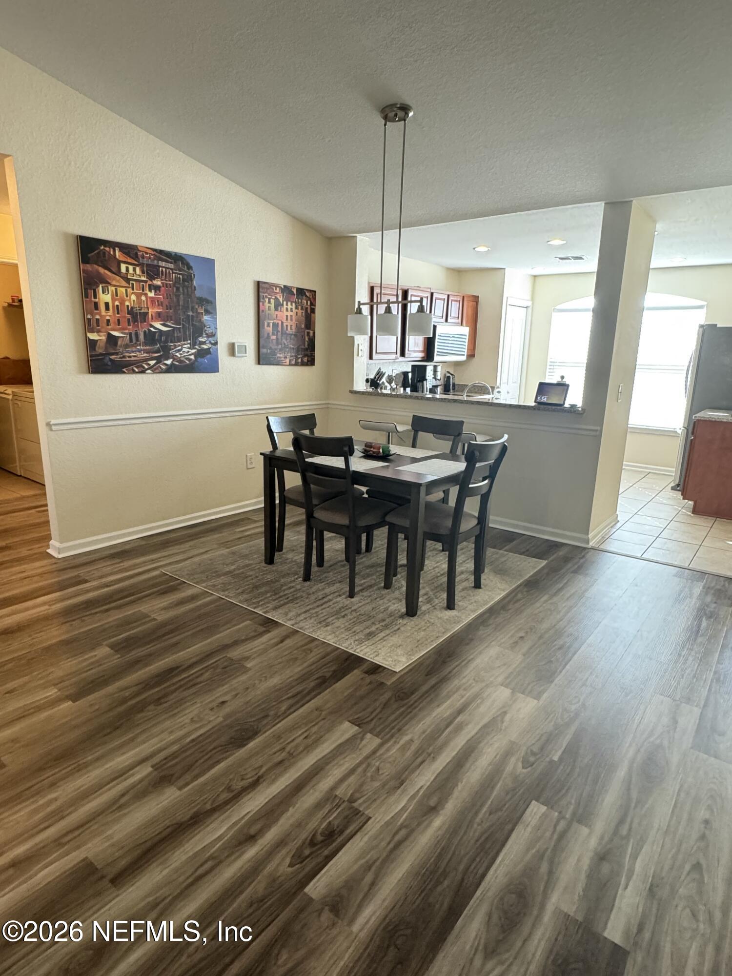 10200 Belle Rive Boulevard, Unit 3603 Jacksonville, FL 32256 - Photo 11 of 19 a view of a dining room with furniture window and wooden floor