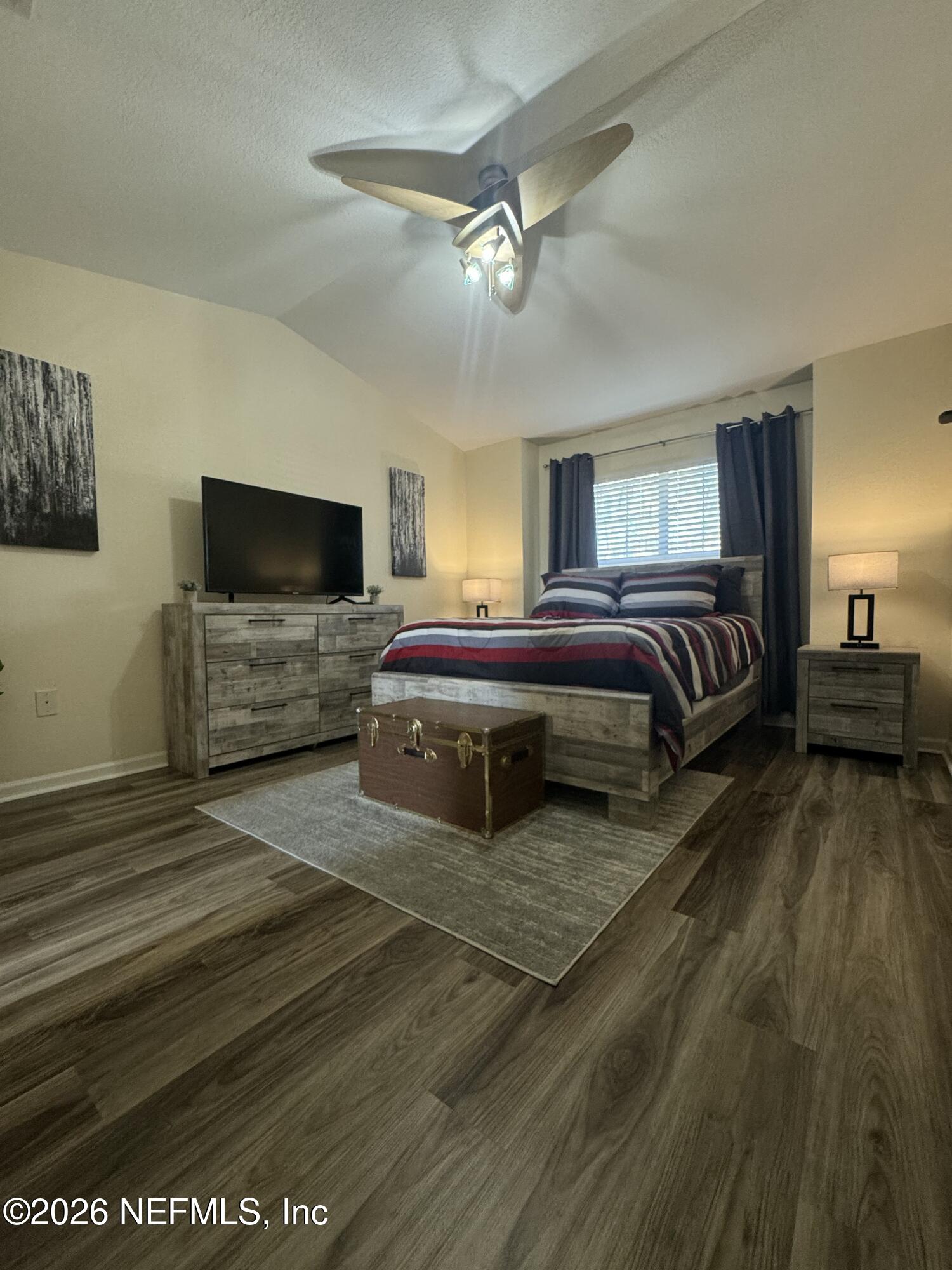 10200 Belle Rive Boulevard, Unit 3603 Jacksonville, FL 32256 - Photo 12 of 19 a spacious bedroom with a bed and a flat screen television