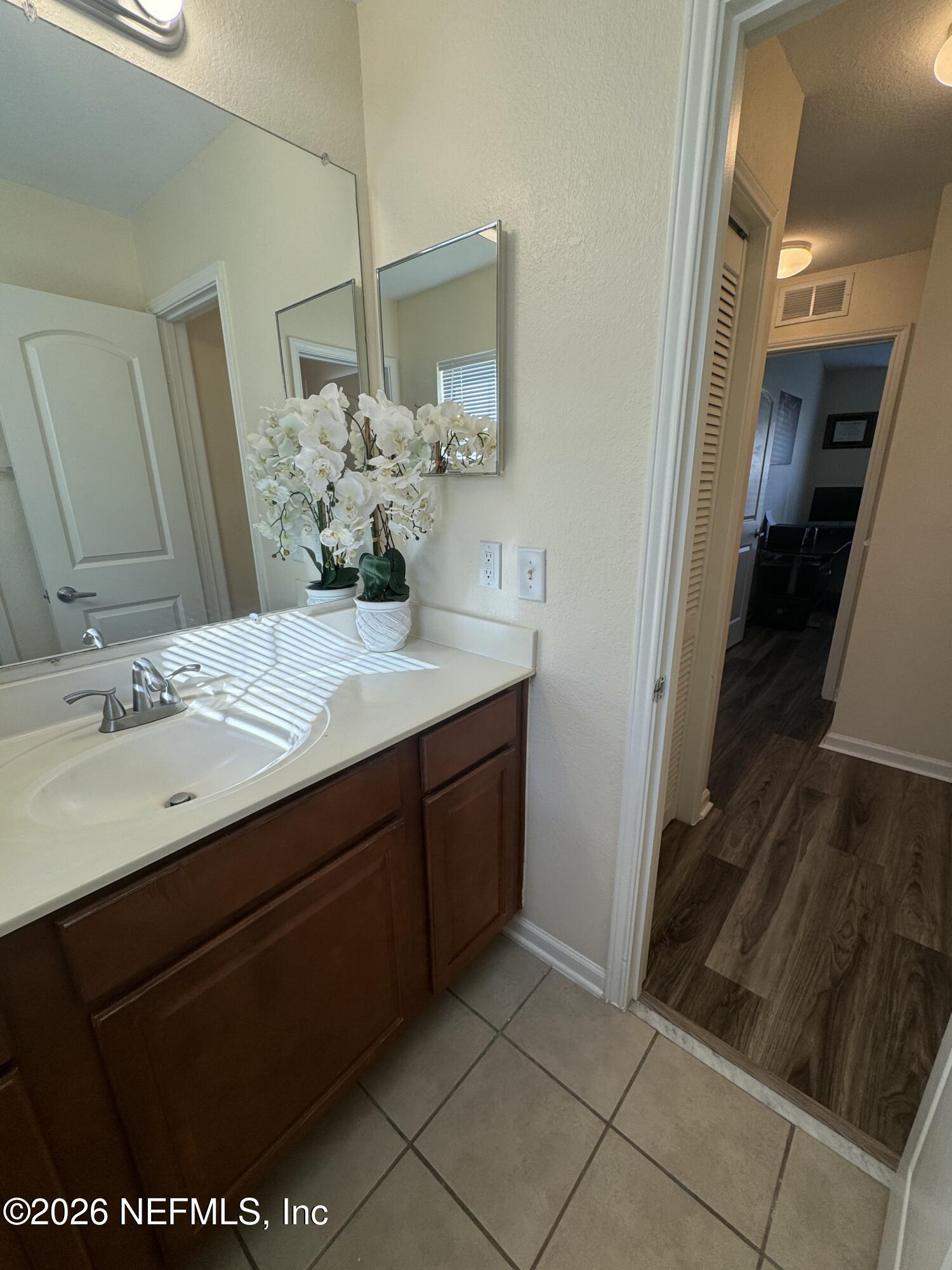 10200 Belle Rive Boulevard, Unit 3603 Jacksonville, FL 32256 - Photo 13 of 19 a bathroom with a sink and a mirror