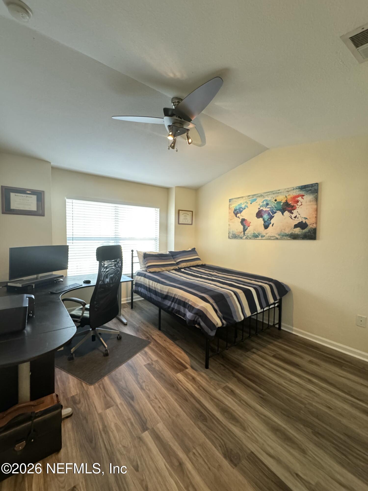 10200 Belle Rive Boulevard, Unit 3603 Jacksonville, FL 32256 - Photo 14 of 19 a bedroom with a bed and a desk