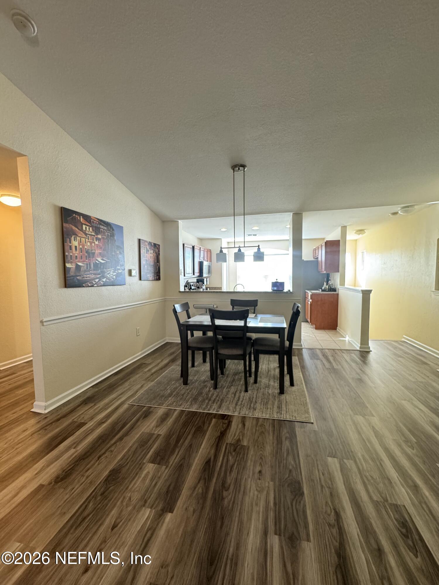 10200 Belle Rive Boulevard, Unit 3603 Jacksonville, FL 32256 - Photo 15 of 19 a dining room with furniture and chandelier