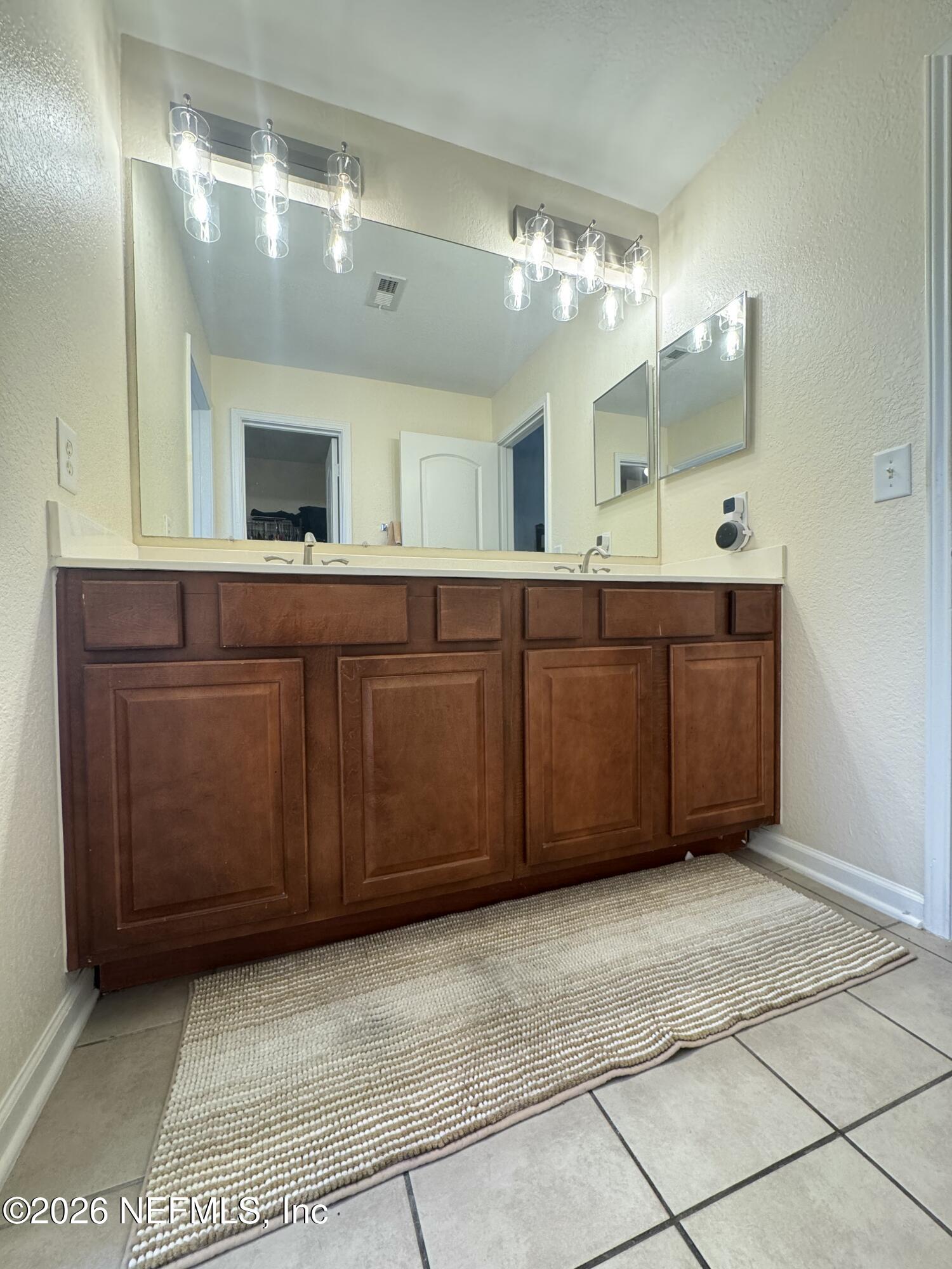 10200 Belle Rive Boulevard, Unit 3603 Jacksonville, FL 32256 - Photo 18 of 19 a bathroom with a sink vanity and mirror