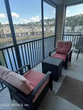 a view of a balcony with furniture