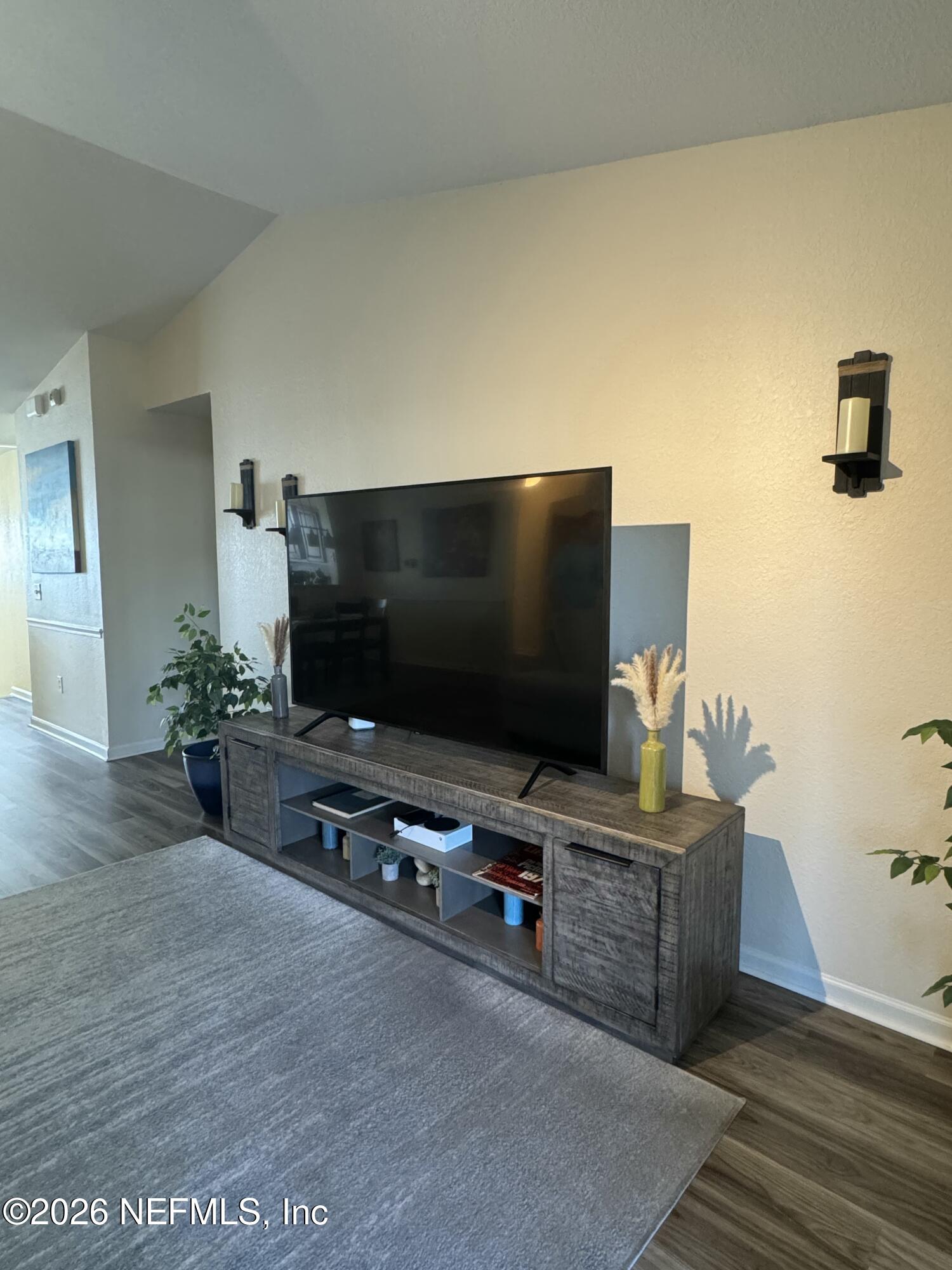 10200 Belle Rive Boulevard, Unit 3603 Jacksonville, FL 32256 - Photo 6 of 19 a living room with furniture and a flat screen tv