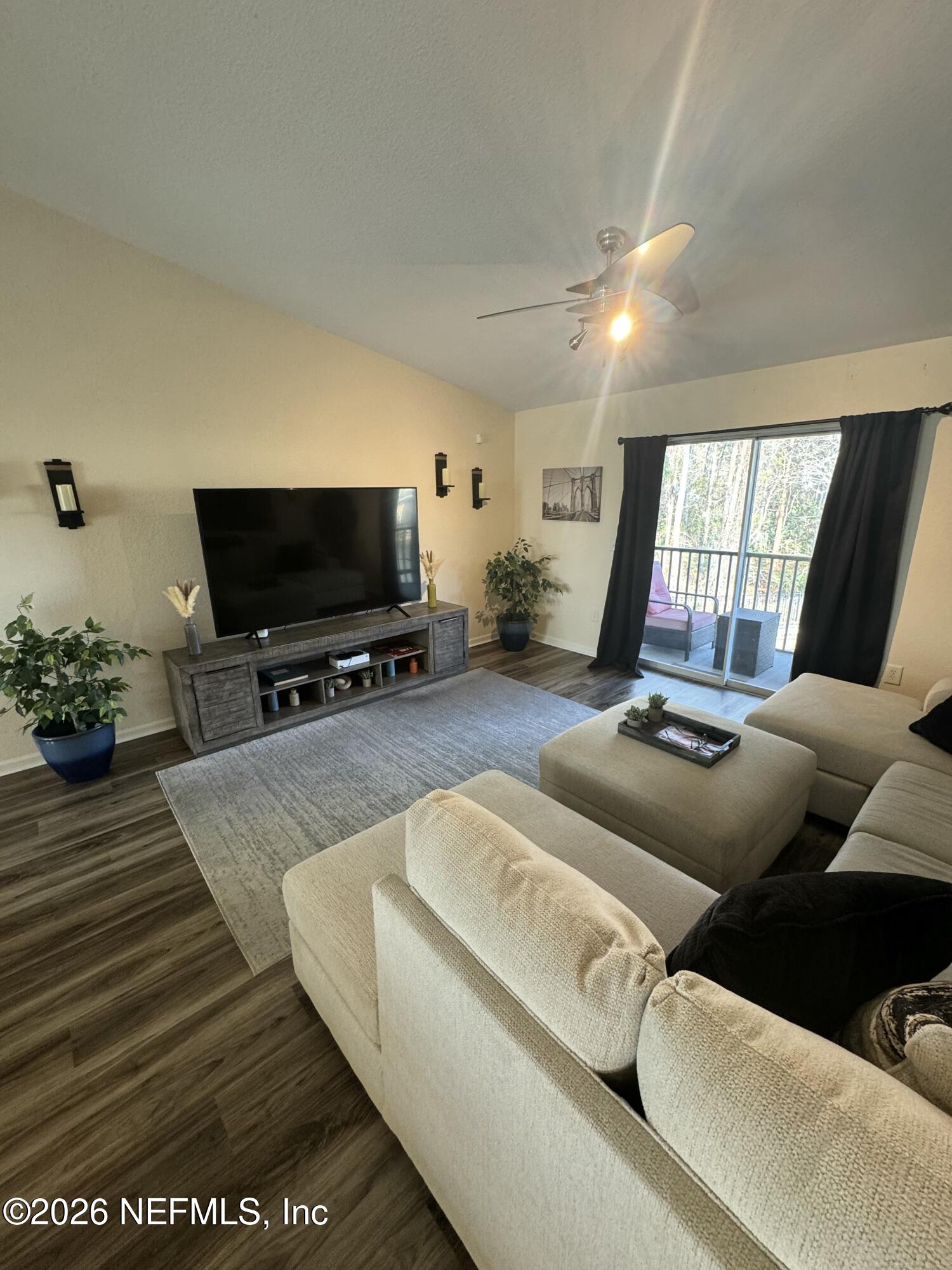 10200 Belle Rive Boulevard, Unit 3603 Jacksonville, FL 32256 - Photo 8 of 19 a living room with furniture and a flat screen tv