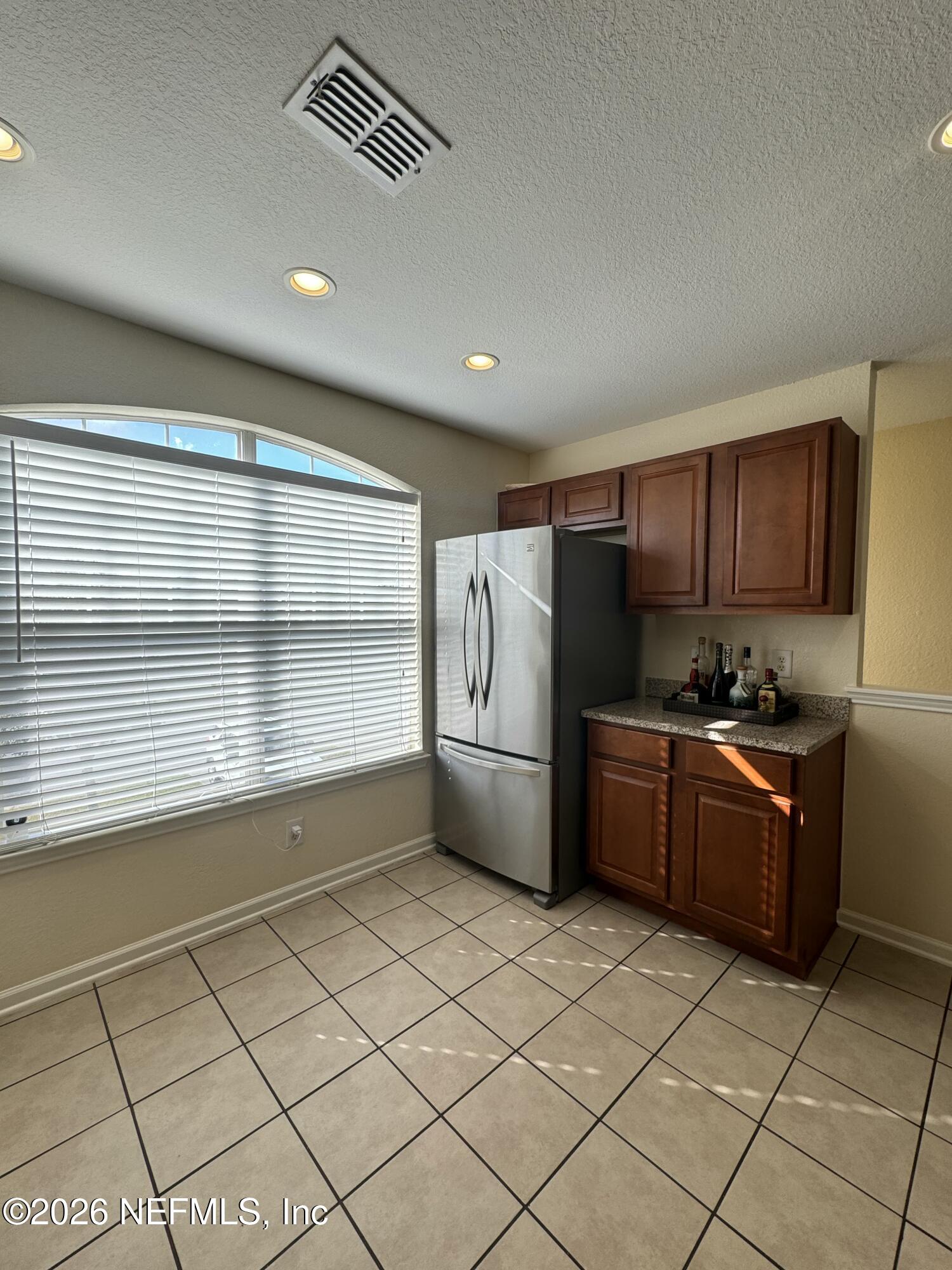 10200 Belle Rive Boulevard, Unit 3603 Jacksonville, FL 32256 - Photo 10 of 19 a kitchen with granite countertop a refrigerator and a stove top oven