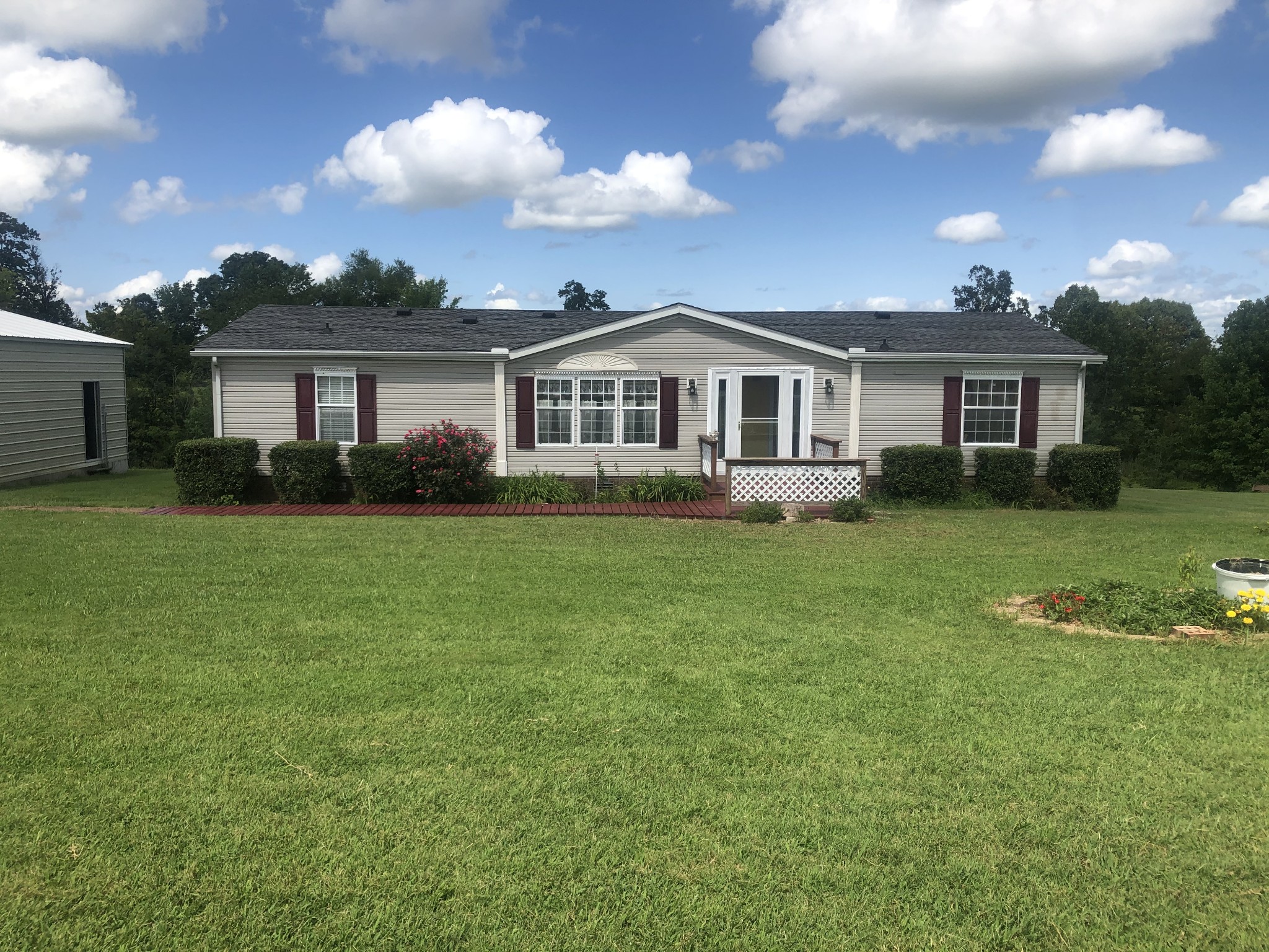 8063 Galen Road Lafayette, TN 37083 - Photo 2 of 18 a front view of a house with a garden