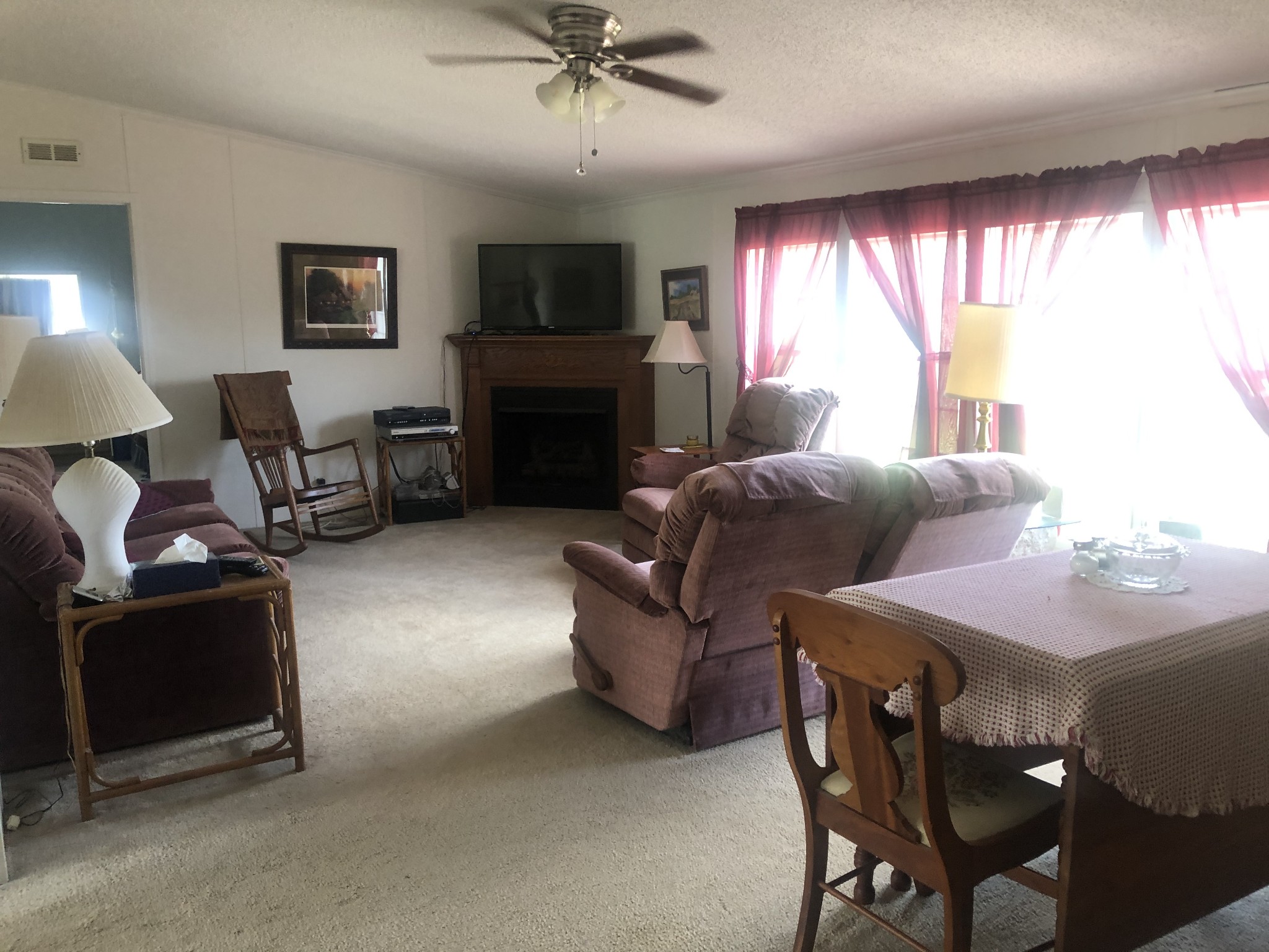 8063 Galen Road Lafayette, TN 37083 - Photo 8 of 18 a living room with furniture a large window and a fireplace