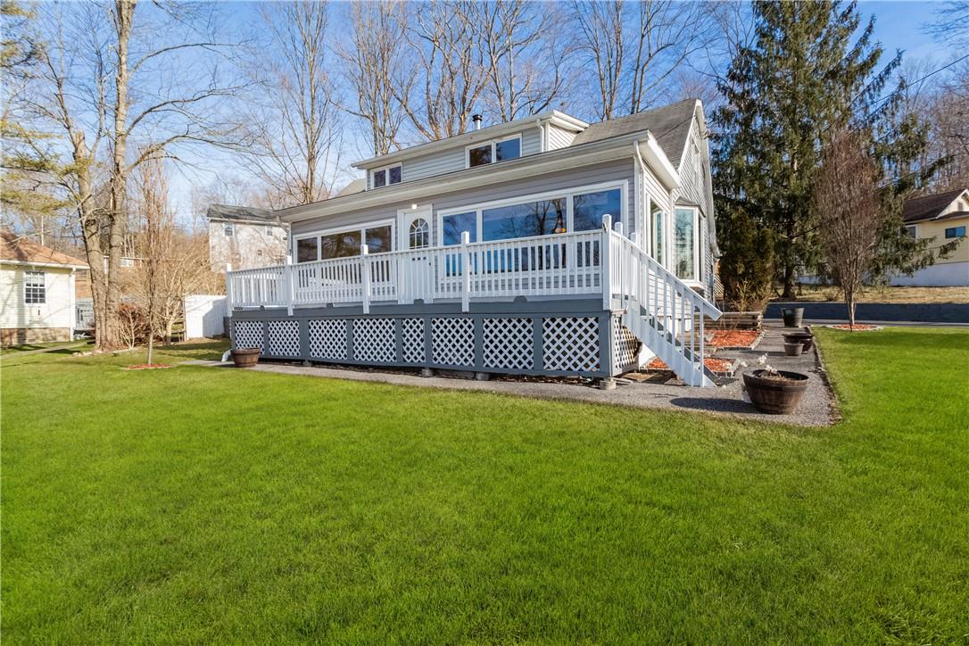a view of a house with a yard and sitting area