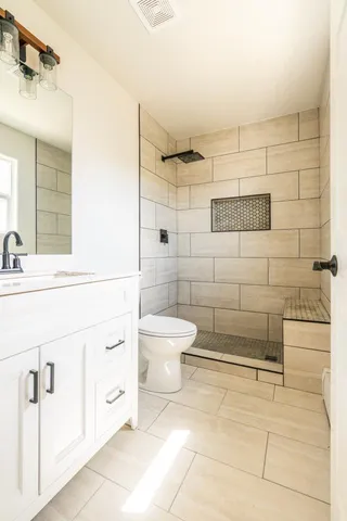a bathroom with a toilet sink and shower