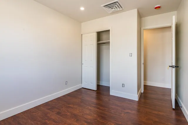 an empty room with wooden floor